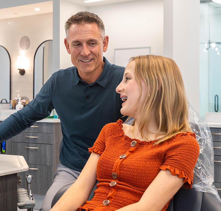 Dr. Russ Ford talks to a young dental patient inside the Ford Orthodontic clinic