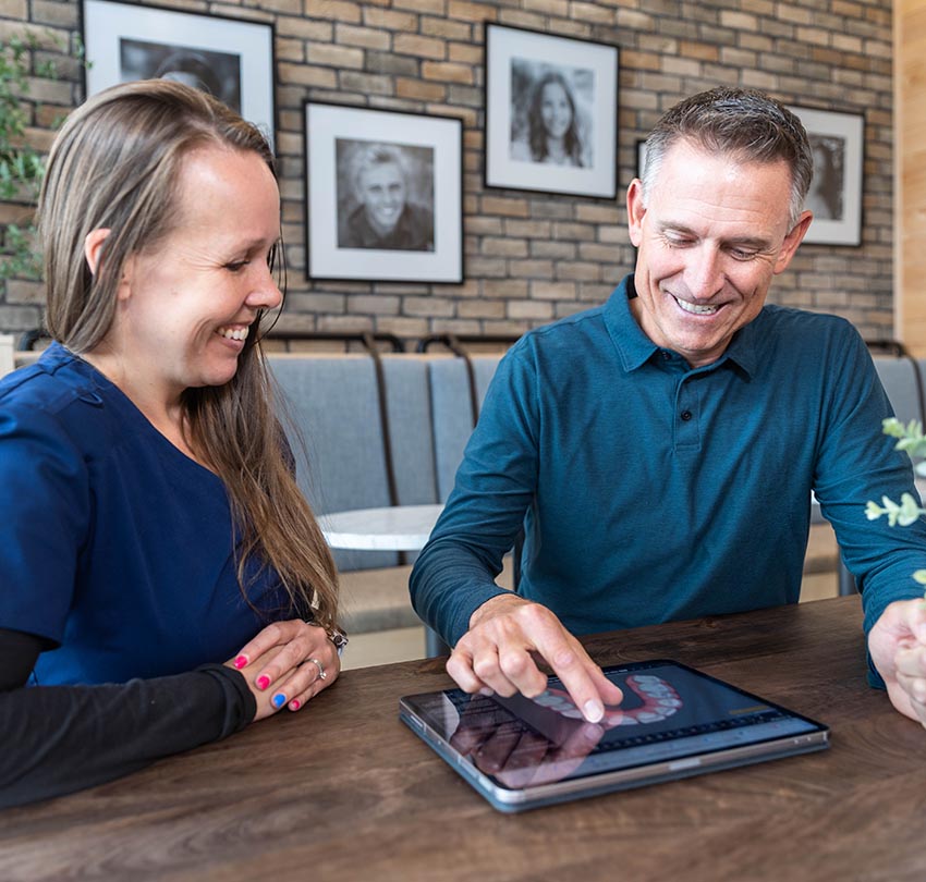 Dr. Russ Ford showing some dental images to a staff member